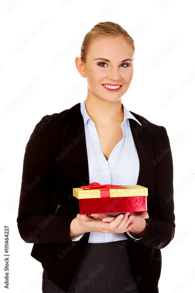 Smiling young business womamn holding present box Smiling young business womamn holding present box