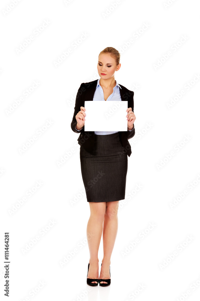 Smiling young businesswoman holding blank banner Smiling young businesswoman holding blank banner