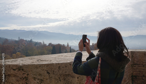 woman taking a photo with smartphone