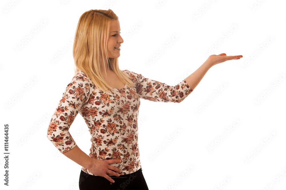 Cute blond woman pointing into copy space as she is showing a pr Cute blond woman pointing into copy space as she is showing a pr