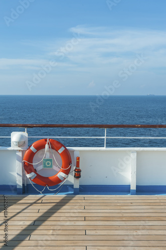 Ship deck, buoy and blue ocean. Travel background