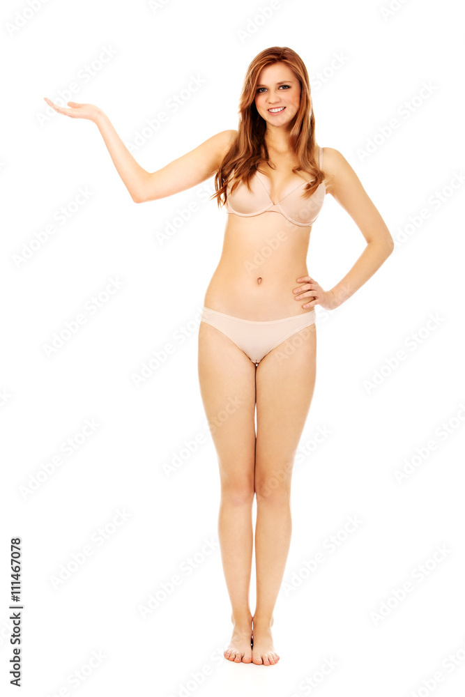 Woman in underwear presenting something on open palm Woman in underwear presenting something on open palm