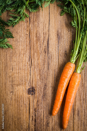 fresh carrots on a wooden background