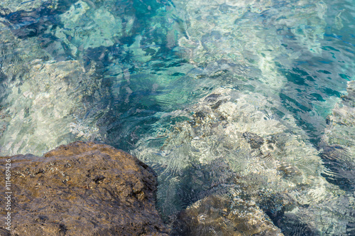 Rock and transparent turquoise water