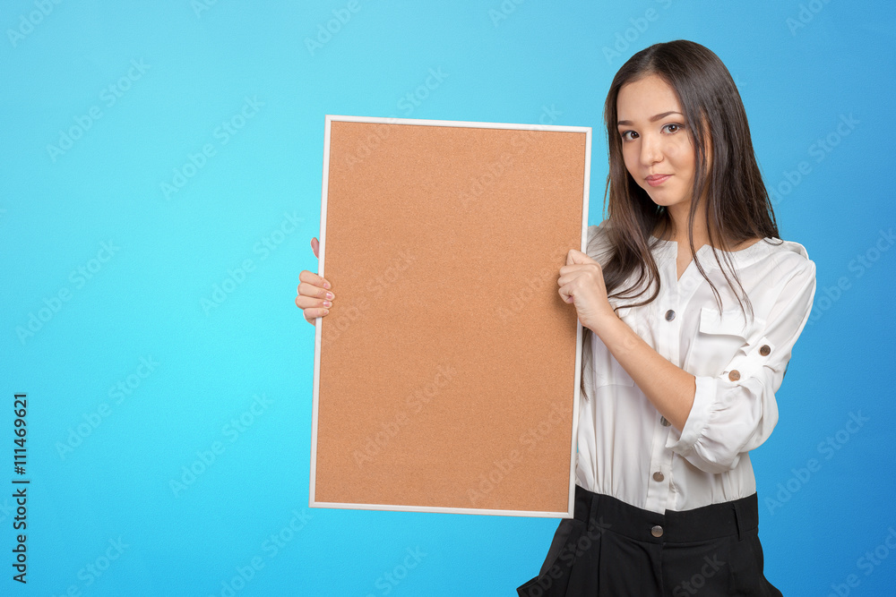 Smiling casual woman holding the empty corkboard Smiling casual woman holding the empty corkboard