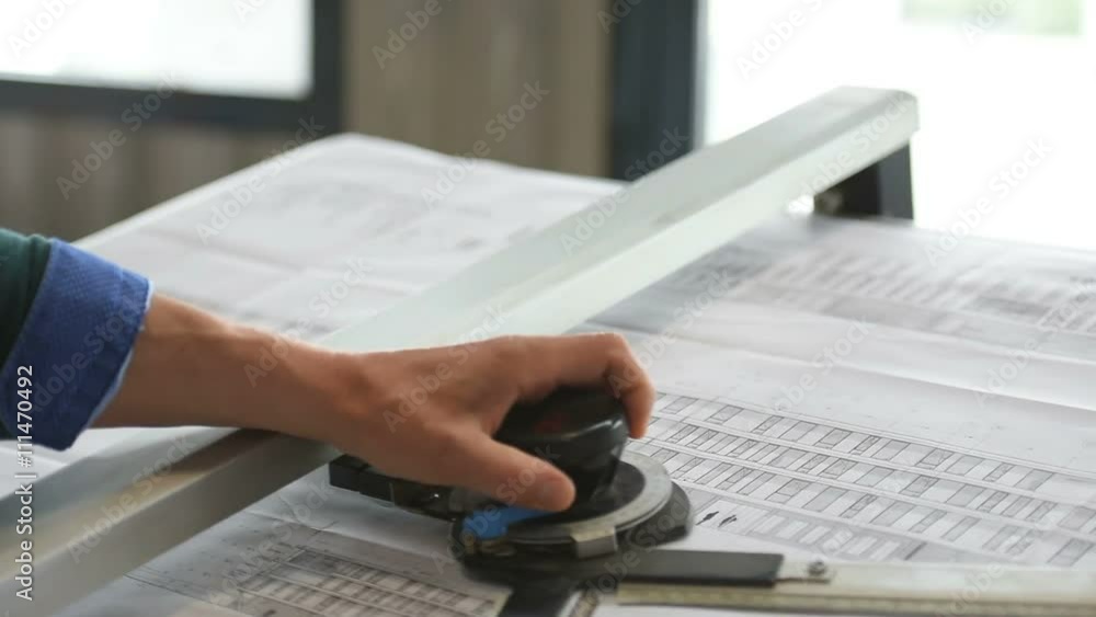 Architect designing on drawing table Architect designing on drawing table