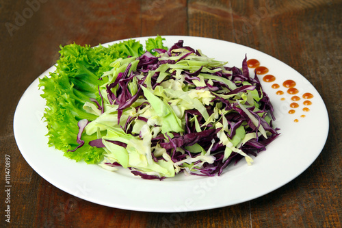 chopped cabbage in a bowl on a wooden table