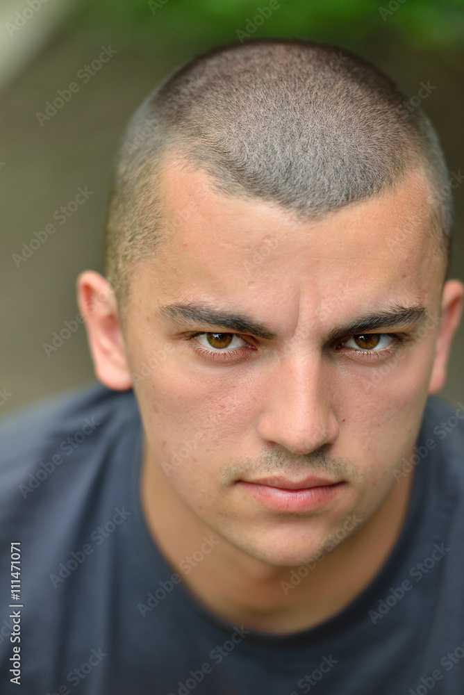 Portrait of serious and sad handsome young man outdoors in natur Portrait of serious and sad handsome young man outdoors in natur