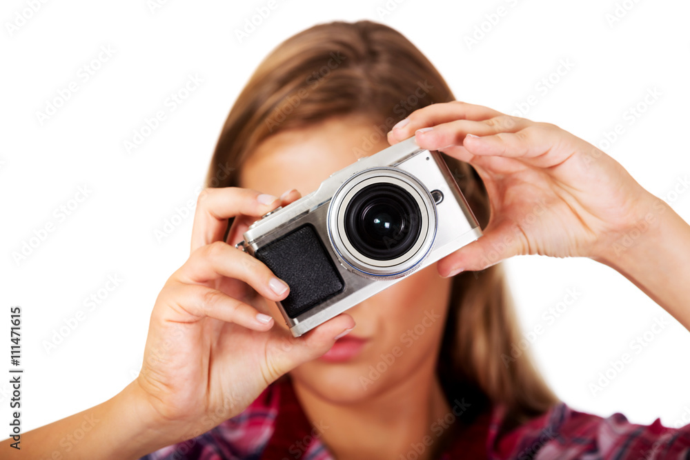 Young smiling woman making a photo through old photo camera Young smiling woman making a photo through old photo camera