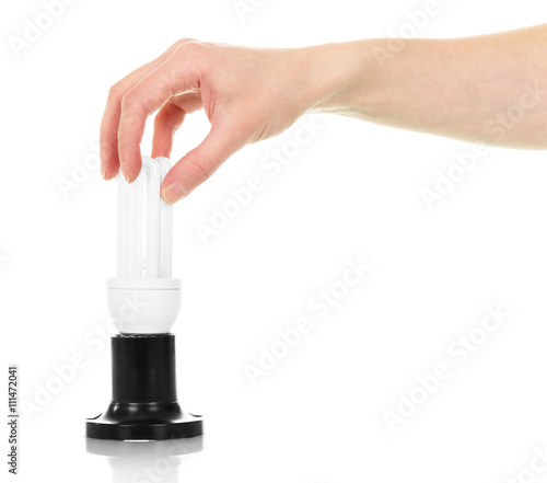 Energy saving light bulb in female hand isolated on white.