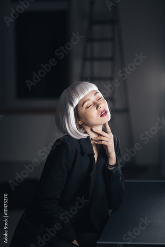 Sensual seductive woman sitting with eyes closed in dressing room © Drobot Dean