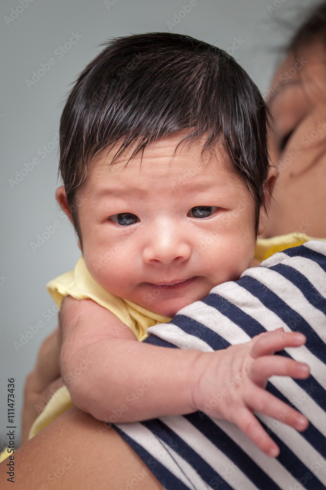 Cute newborn baby boy on his mother shoulder Cute newborn baby boy on his mother shoulder
