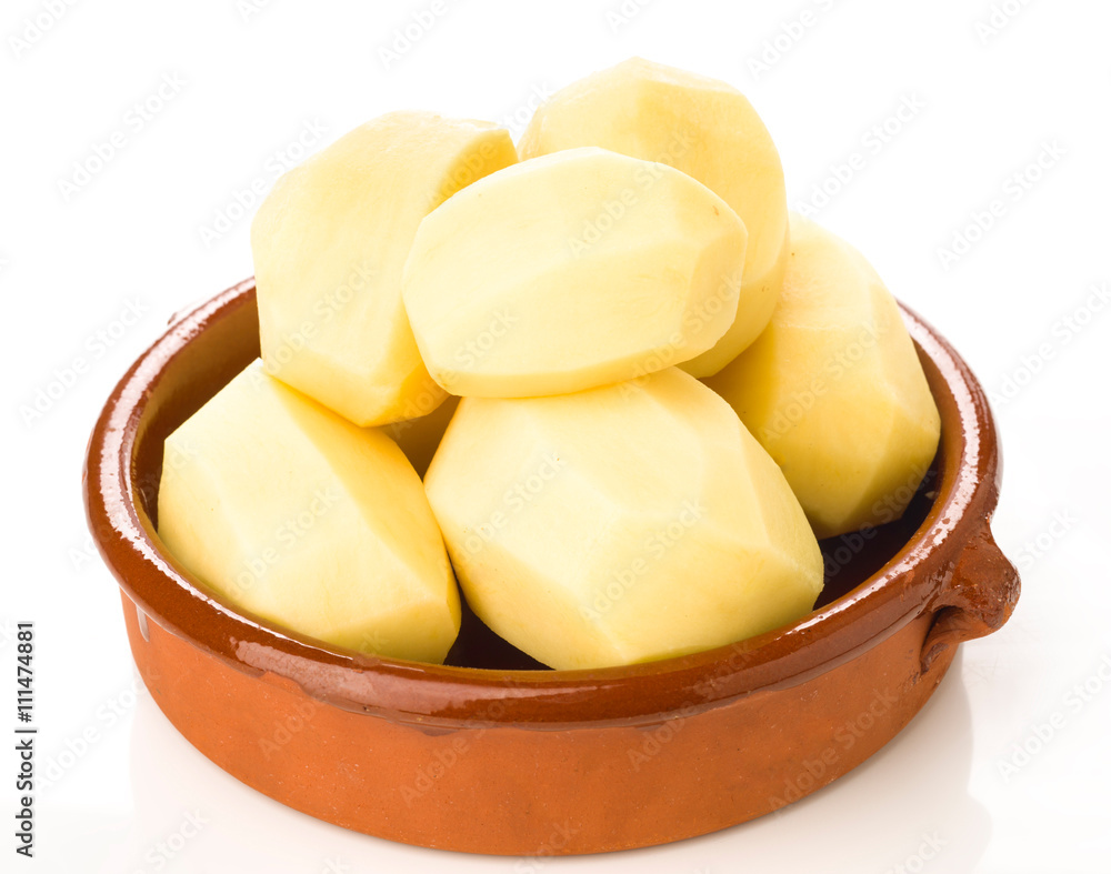 earthenware dish with raw potatoes isolated earthenware dish with raw potatoes isolated
