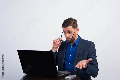 Young businessman surprised data on the laptop