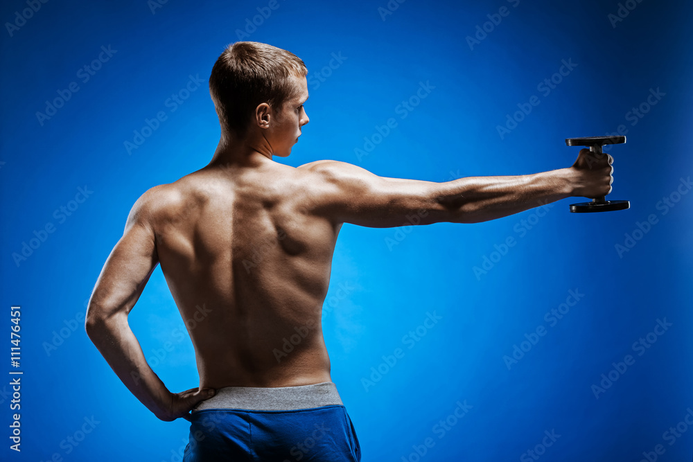 Fit young man with beautiful torso on blue background