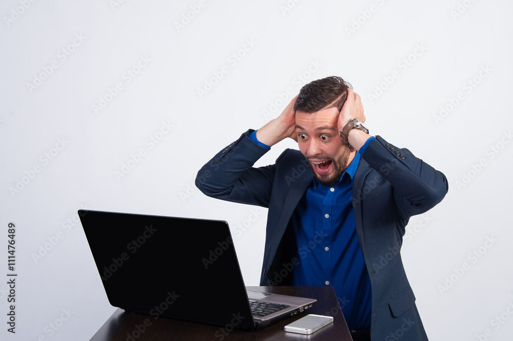 happy young businessman on the laptop information happy young businessman on the laptop information