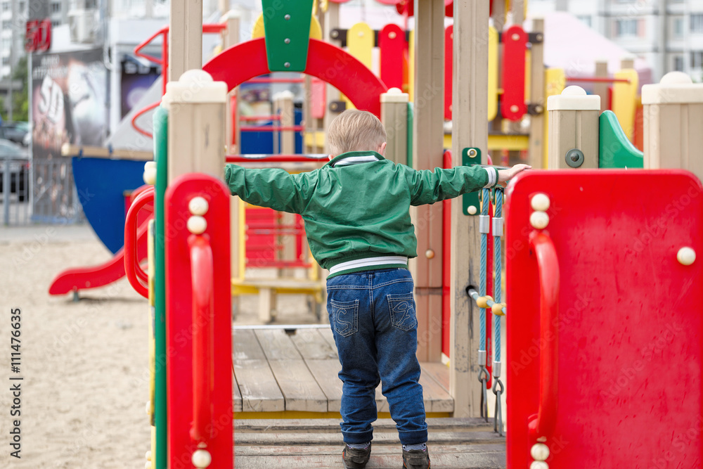 children play on the playground. early spring children play on the playground. early spring