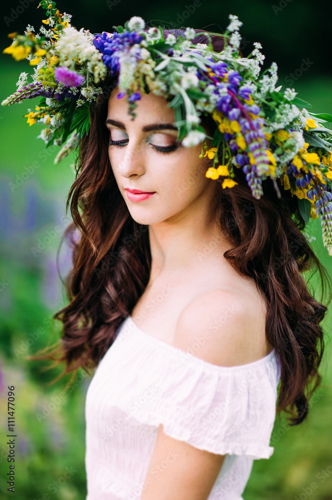 Portrait of girl looking down with wreath on head Portrait of girl looking down with wreath on head