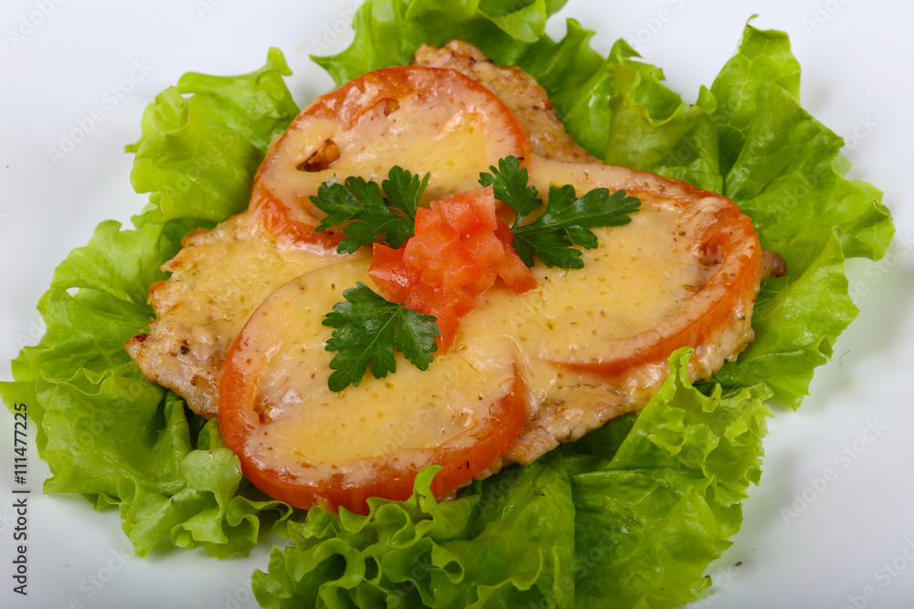 Pork baked with tomato and cheese