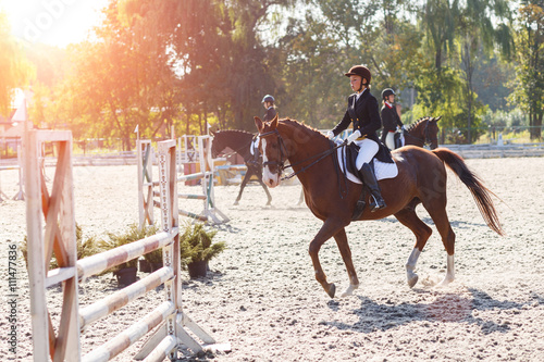 Fotografia, Obraz Young girl riding horse in equestrian competition