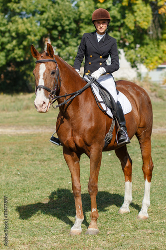 Young teenage girl riding horse. Equestrian sport © skumer
