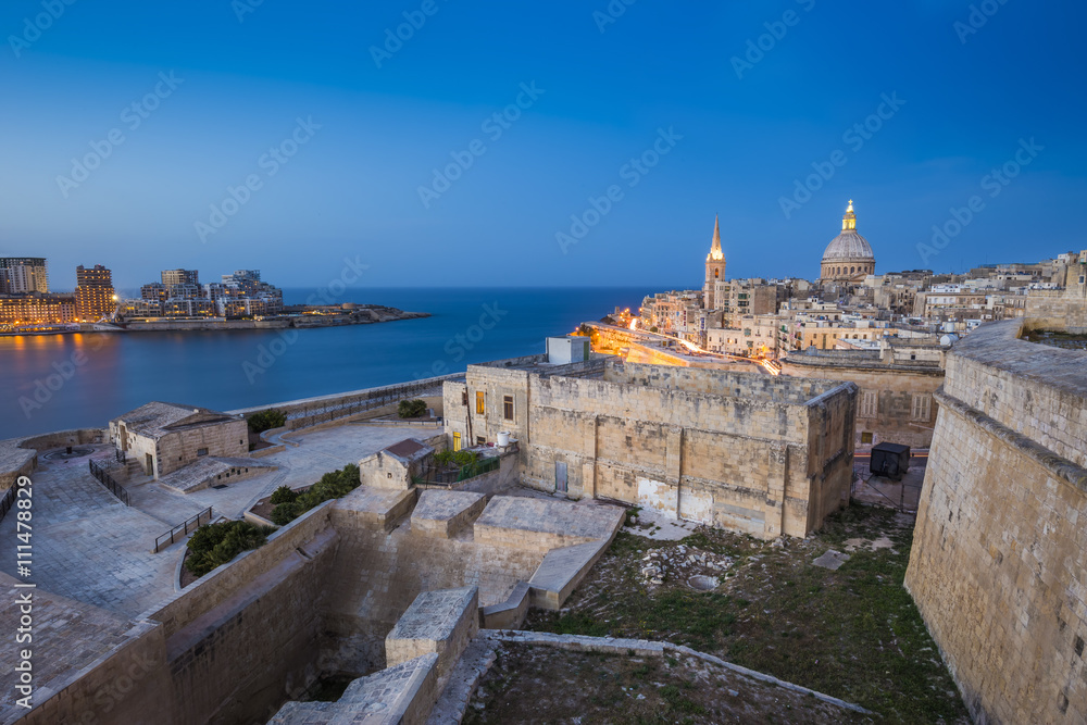 Valletta, Malta - Ancient walls of Valletta and St.Paul's Anglican Cathedral and houses of Sliema at blue hour