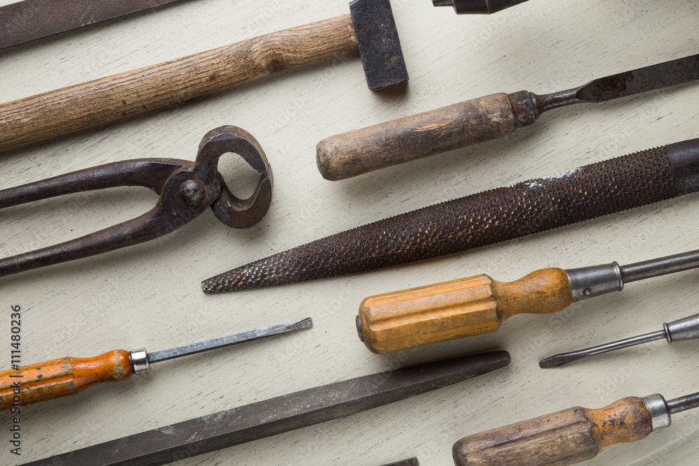 Accessory, assorted tools set on wooden light background. Construction assortment instruments for repairman, carpenter, builder. Copy space for text. Top view. Accessory, assorted tools set on wooden light background. Construction assortment instruments for repairman, carpenter, builder. Copy space for text. Top view.