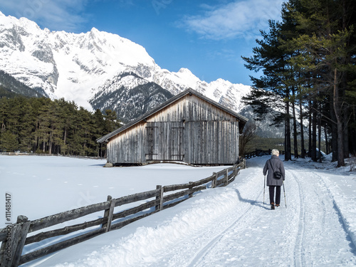 Seniorin beim Schneespaziergang in Tirol photo