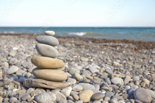 Stone pyramid on a pebble beach