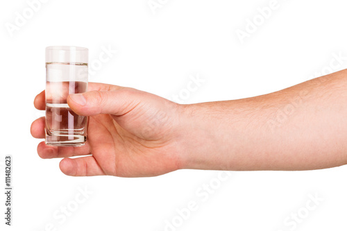Man's hand keeps glass vodka isolated on white background.