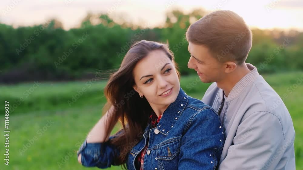 Young couple embracing. The guy embraces and kisses the girl Young couple embracing. The guy embraces and kisses the girl