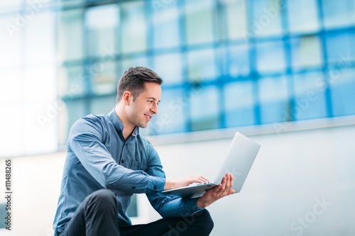 Man using a laptop outdoors