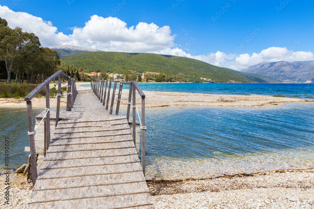 Wooden pedestrian bridge on greek beach