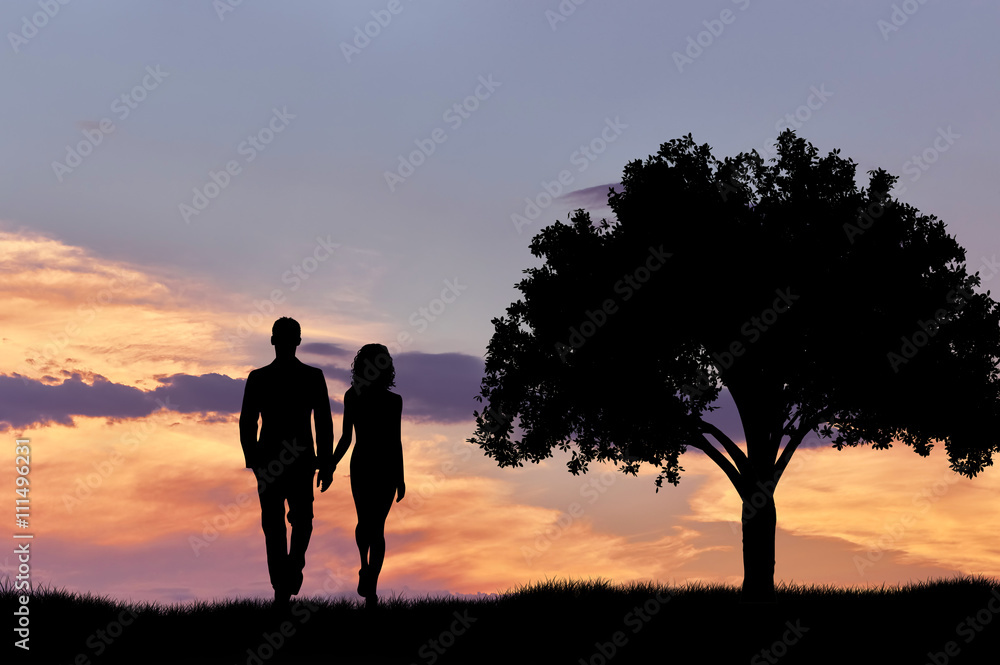 Silhouette of a couple walking at sunset near a tree