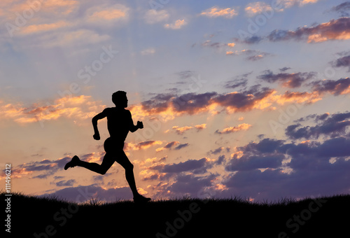 Fototapeta Naklejka Na Ścianę i Meble -  Silhouette of man runner at sunset
