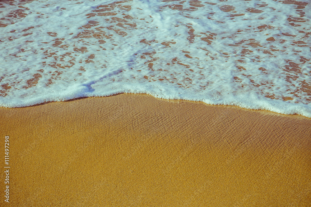 Soft foam wave of sea on sandy beach