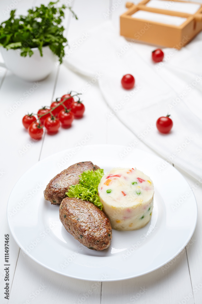 Meat fried cutlets with mashed potatoes dietetic food and salad on white plate.