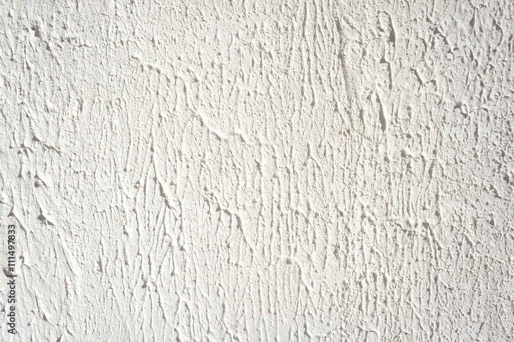 Plaster wall texture. White stucco textured wall background with natural light Plaster wall texture. White stucco textured wall background with natural light