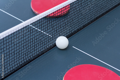 Ping Pong: composition of two old scratched rackets with grid and ball 