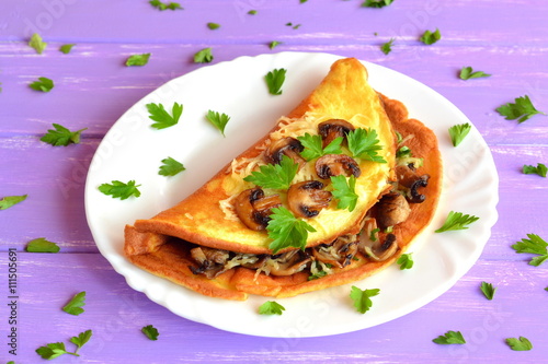 Mushroom and cheese omelet with herbs. Breakfast egg recipe. Omelette filling idea. Cooking scrambled eggs. Pan fried omelette