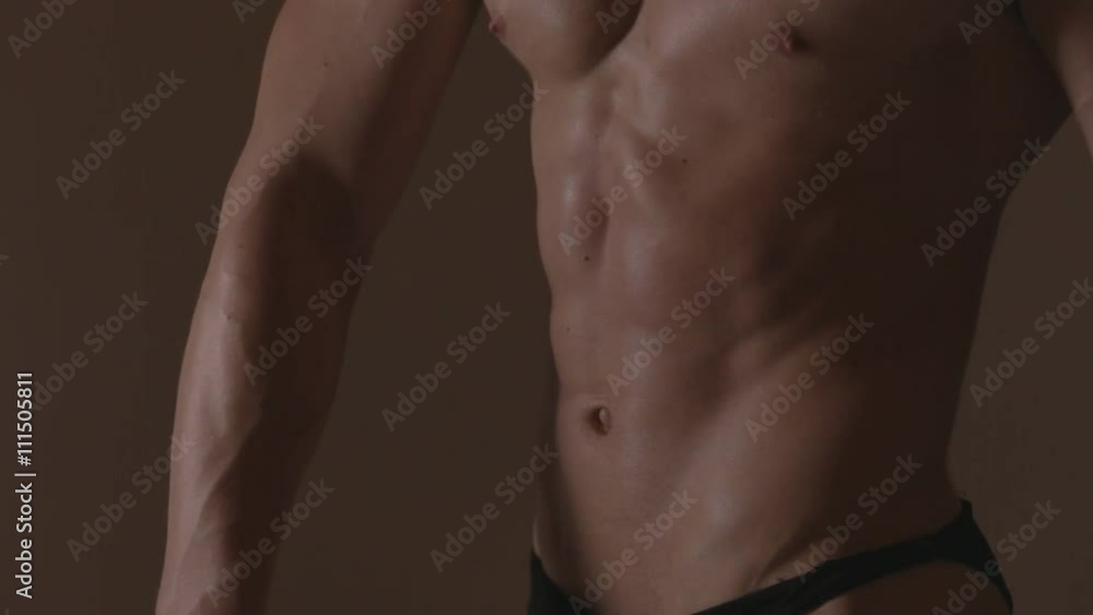 Brutal guy showing his muscles. Abs. Ungraded Brutal guy showing his muscles. Abs. Ungraded