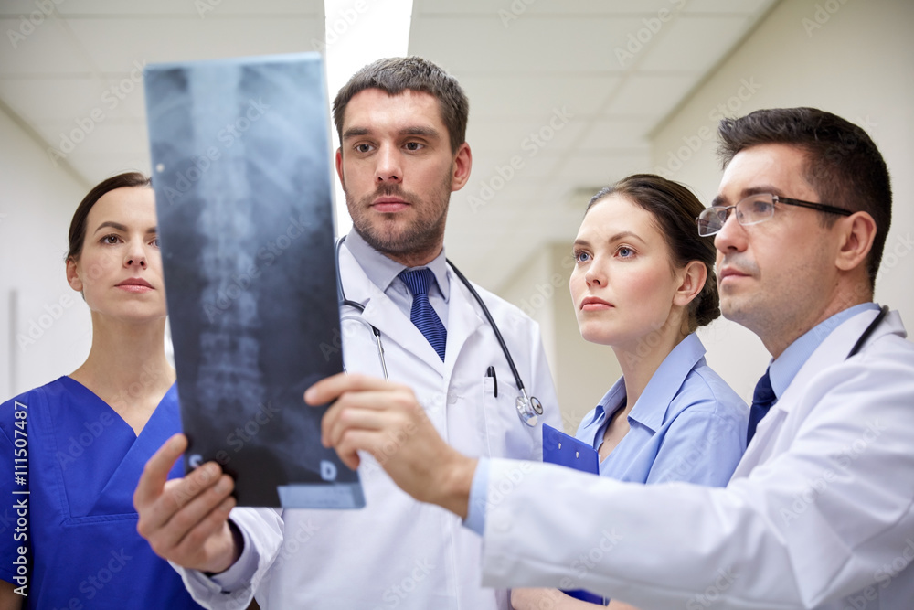 group of doctors looking at x-ray scan image group of doctors looking at x-ray scan image