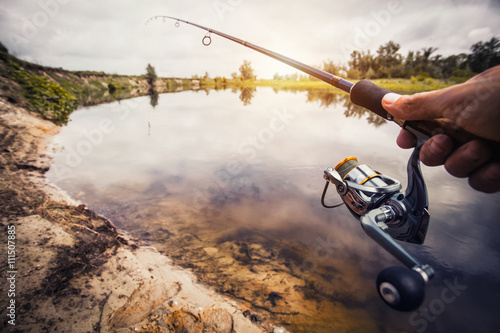 Fishing with rod on lake