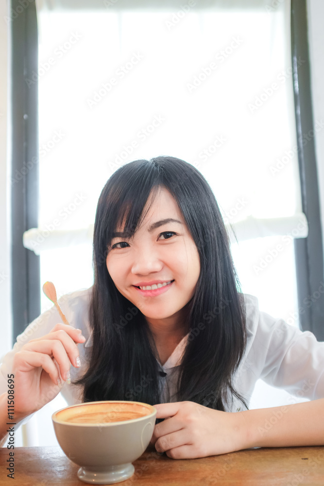 Beautiful woman with coffee cup in coffee shop Beautiful woman with coffee cup in coffee shop
