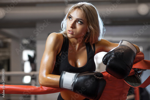 Young pretty boxer woman standing on ring © tolstnev