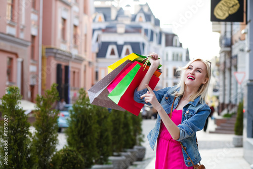 Smiling girl with shopping bags.