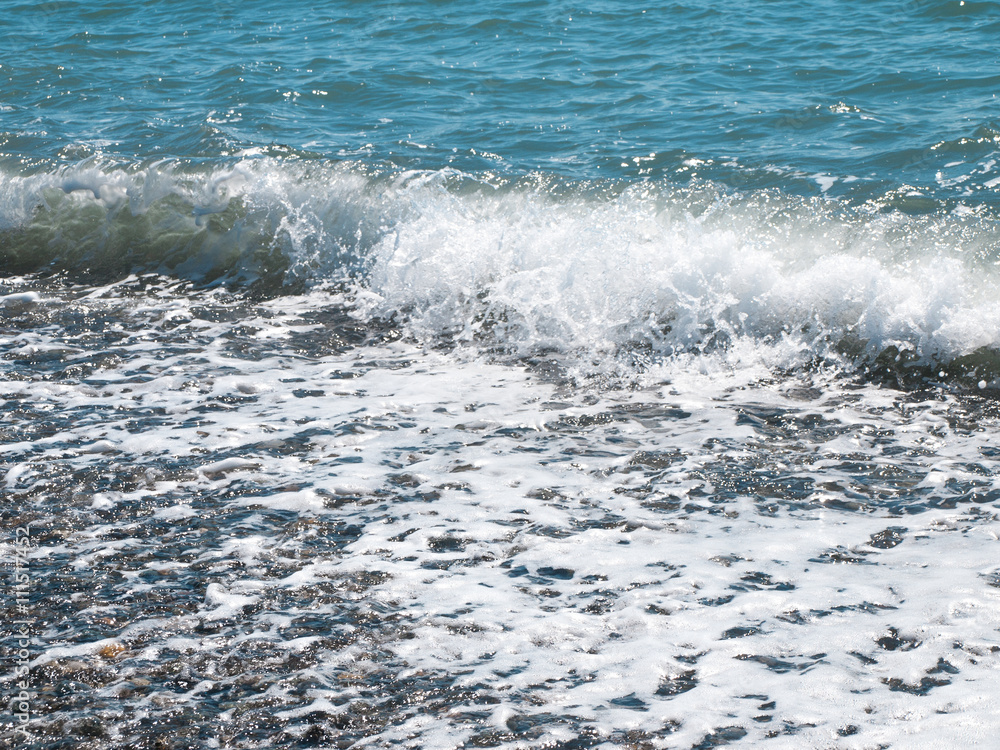 Wave splash on pebble beach Wave splash on pebble beach
