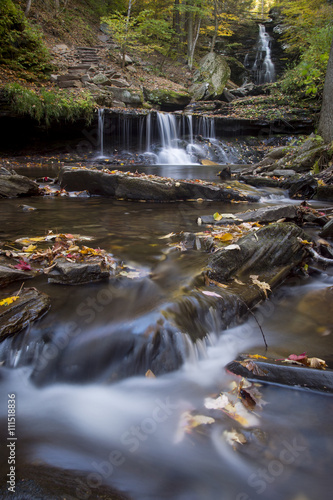 A small waterfall surrounded by bright fall colors.