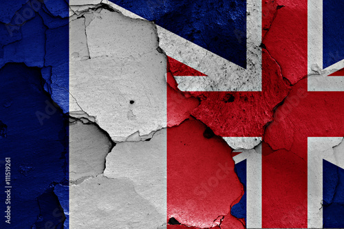 flags of France and UK painted on cracked wall