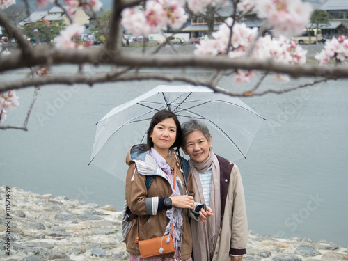 Senior mother and daughter with umbrella at Nishikyo-ku, Kyoto, Japan